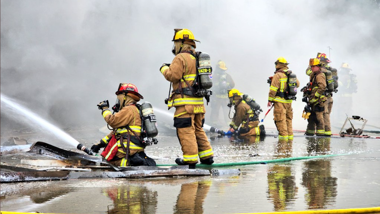 Dallas firefighters battle a four-alarm commercial fire Friday morning.