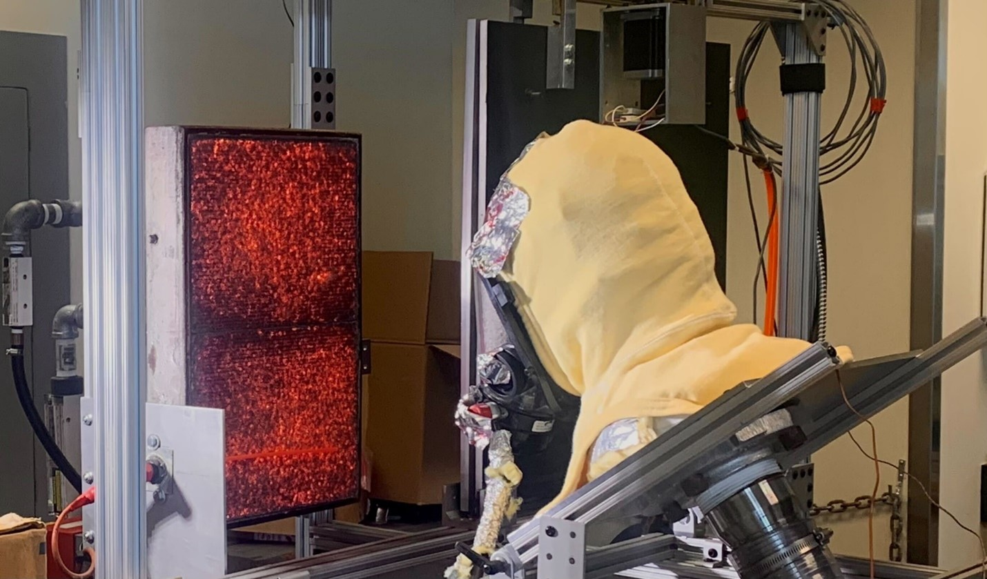 SCBA facepiece being exposed to radiant heat flux from a natural-gas fired panel.