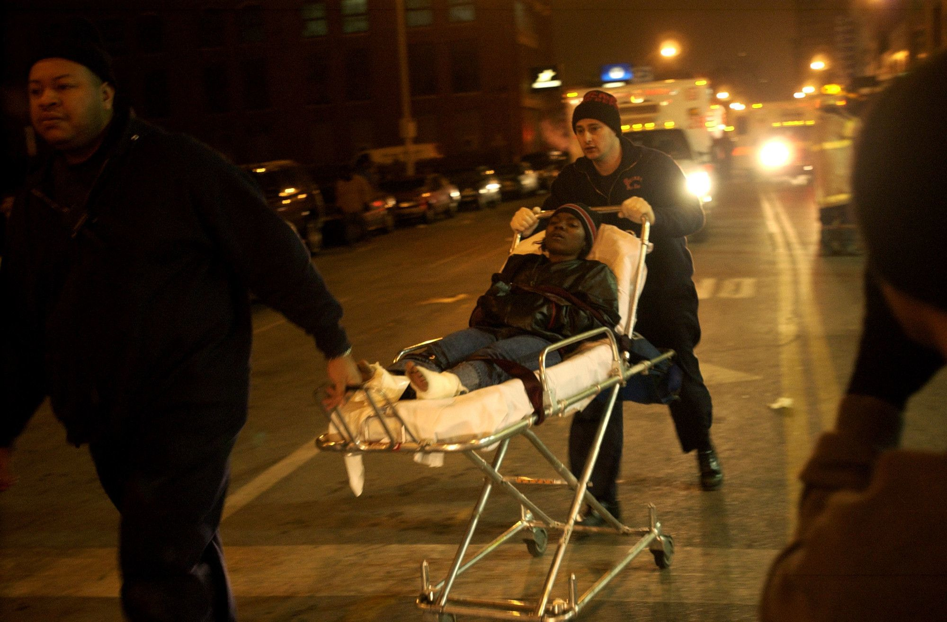 A victim is rushed to an ambulance,