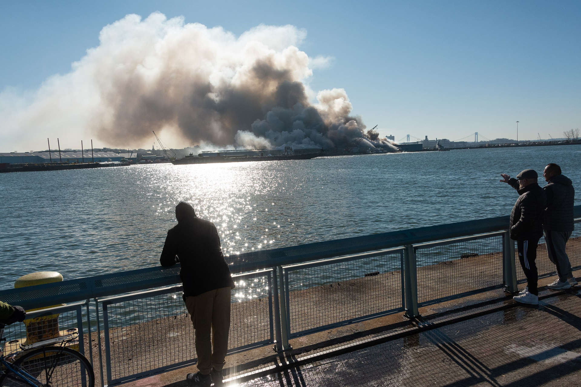 People watch the warehouse burn on Dec. 13.