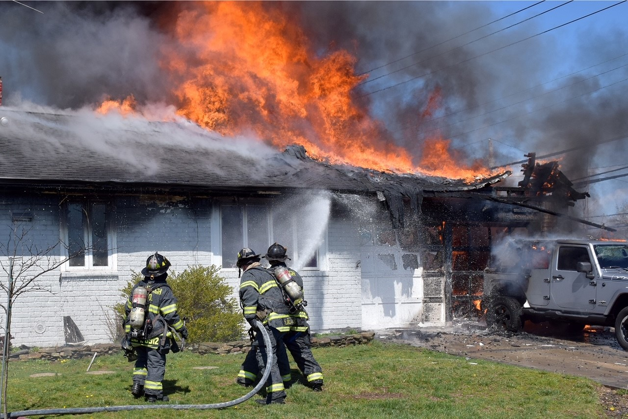When Wantagh, NY, Fire Department Assistant Chief Leonard Mathewson arrived at the address of a reported house fire, flames were extending out of the garage on the A/D corner of a residence. Mathewson requested a working fire be transmitted. Engine 2 was the first engine on scene. The crew hooked up to a hydrant that was in front of the house. The automobile and the garage at the house were on fire.