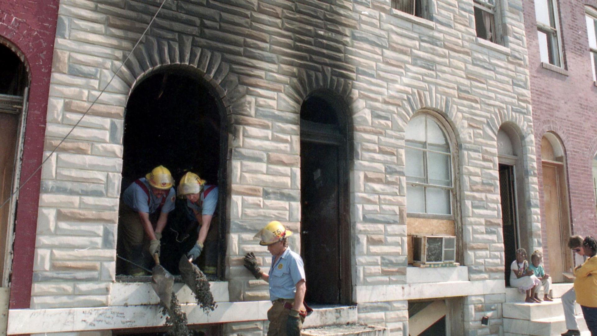 Fire investigators work at the scene where six children died in 1992.