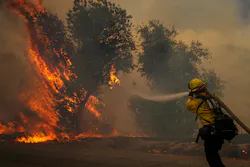A firefighter hits a wildland blaze in California last year. A firefighter hits a wildland blaze in California last year.