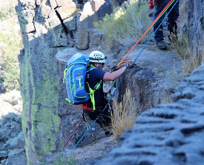 A Magic Valley Paramedics&rsquo; Special Operations Reach and Treat (SORT) team member is lowered over the side of the Snake River Canyon to begin to treat an injured hiker.