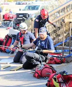 Two SORT team members manage rope systems during a rescue while supported by a Twin Falls Fire Department (TFFD) firefighter. Two SORT team members manage rope systems during a rescue while supported by a Twin Falls Fire Department (TFFD) firefighter.
