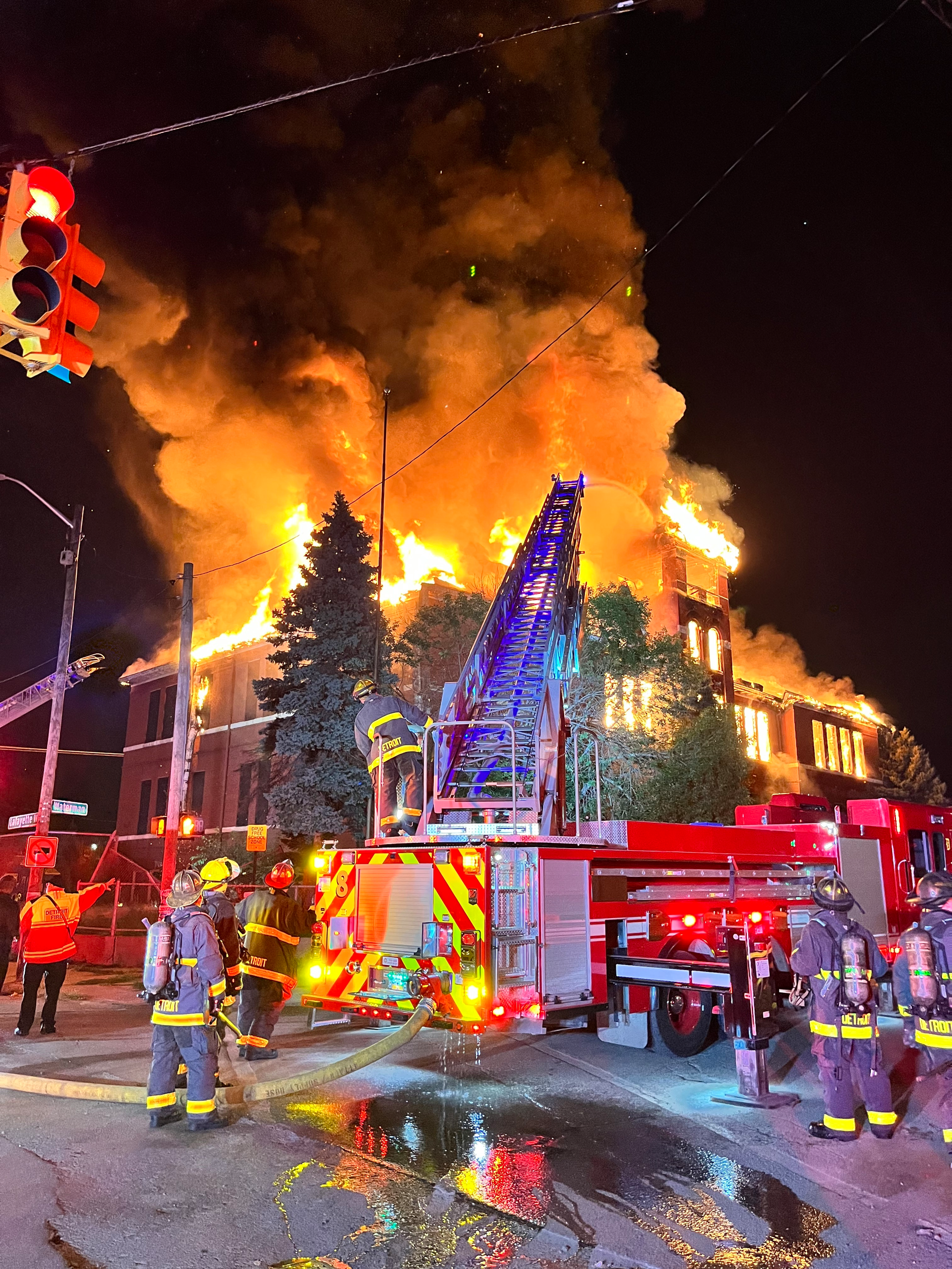 Firefighters battle a fire at a vacant school