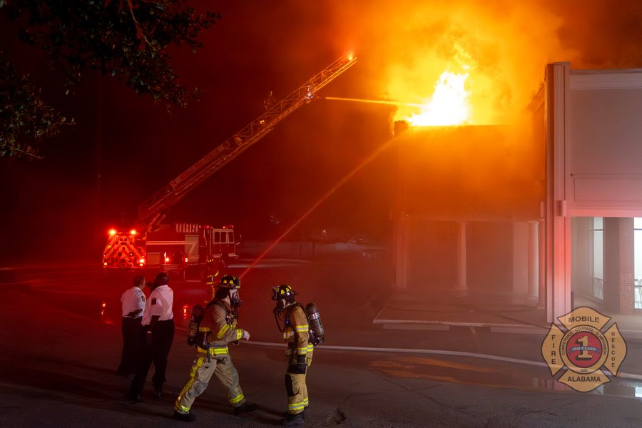 Mobile firefighters tackle flames at a strip mall.