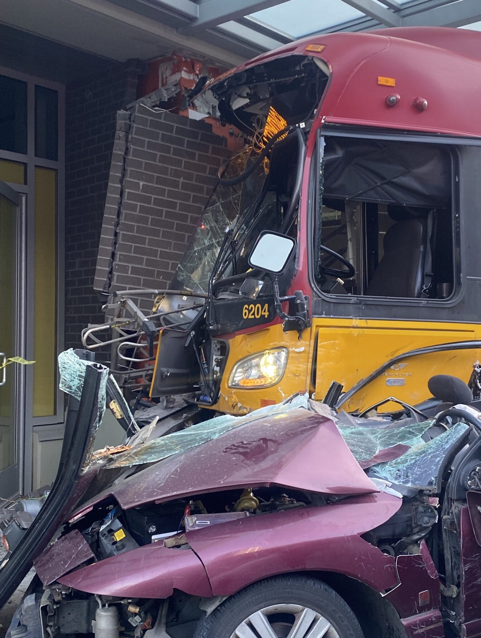 A pedestrian outside the Seattle building was killed and a car driver was rescued after a King County Metro bus crashed Saturday.