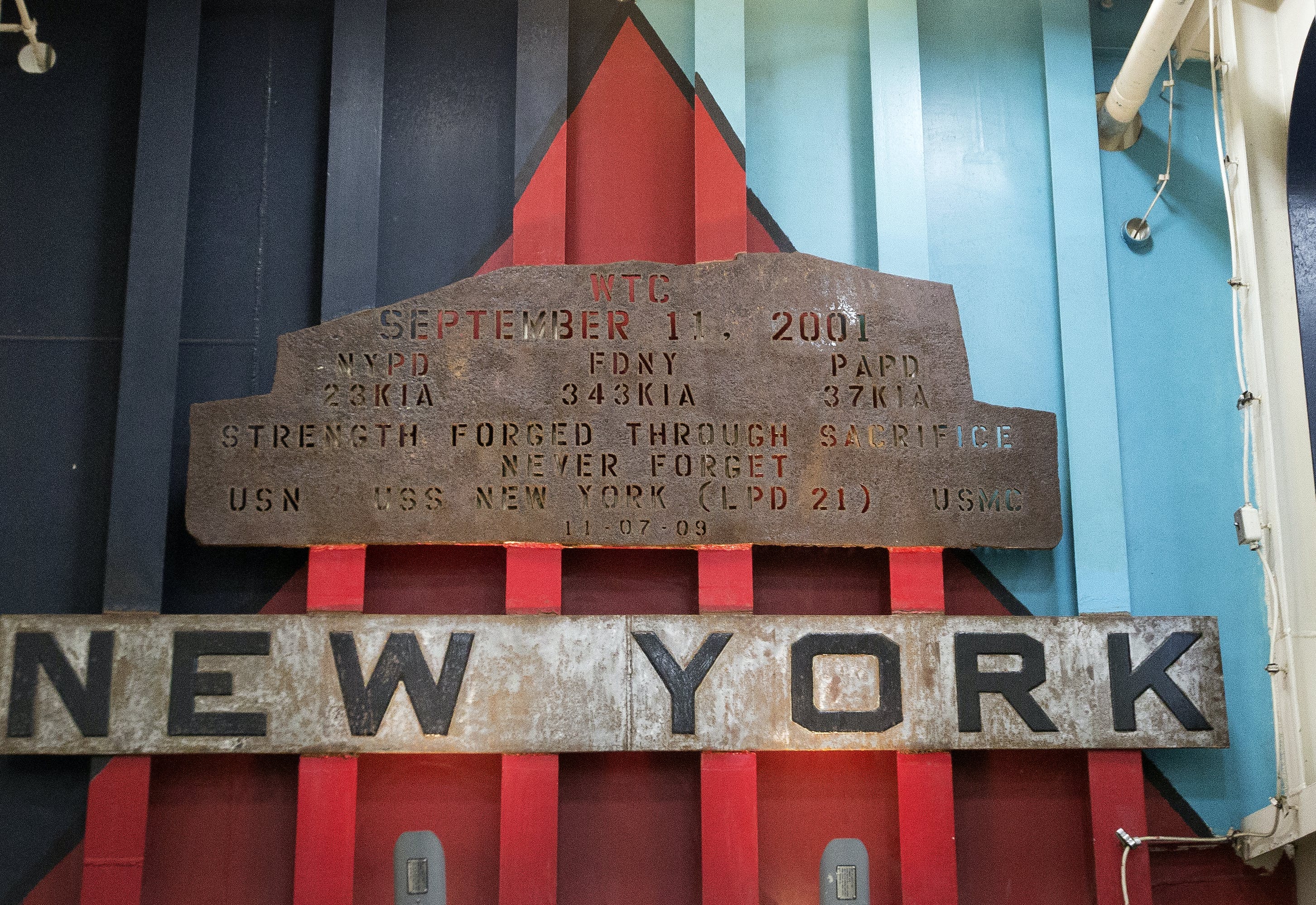 A piece of rusted steel from the Work Trade Center, hangs over the ramp on the USS New York.