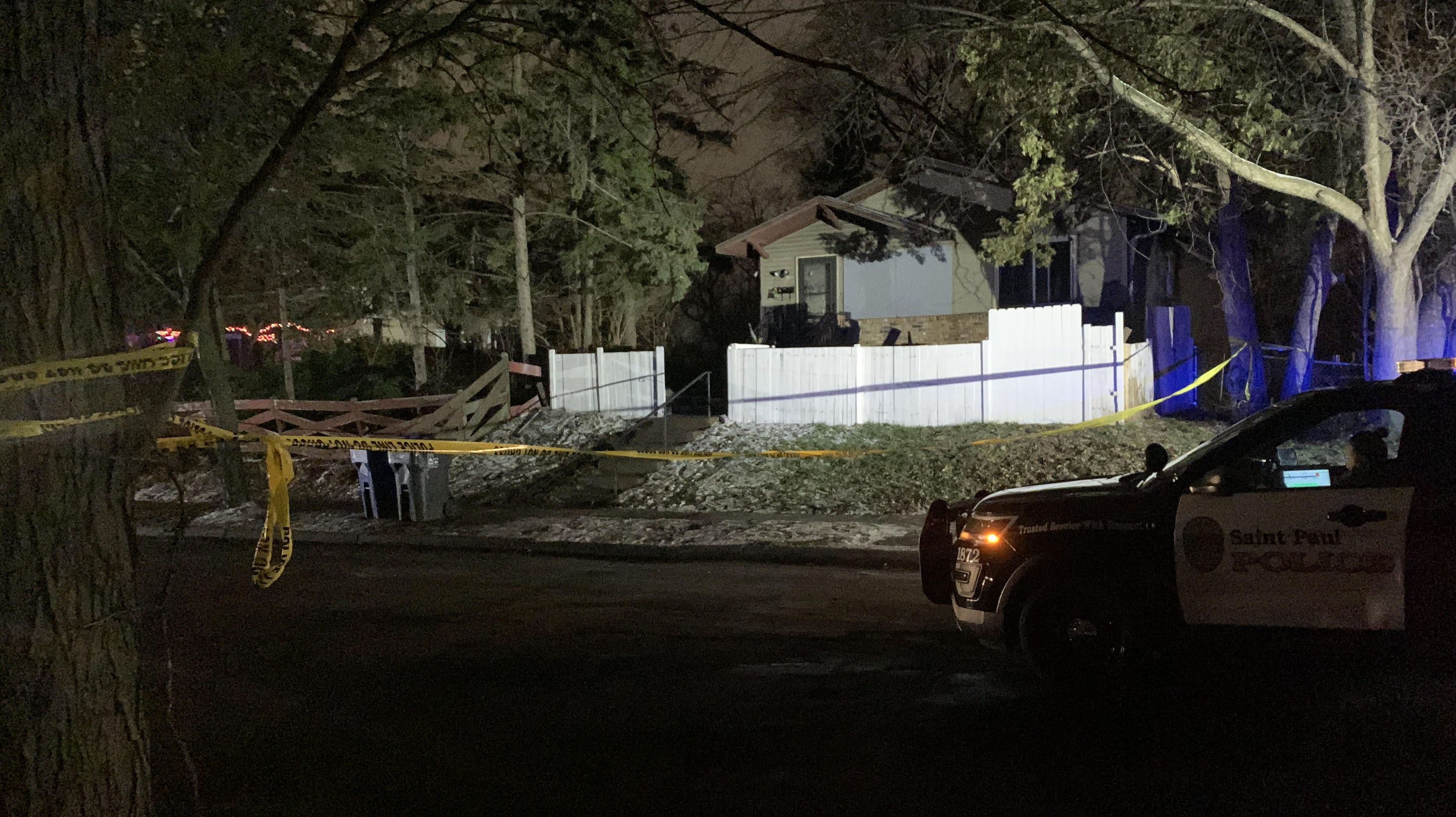 A St. Paul police squad car parked outside the home where a house fire claimed three lives and several left others injured.