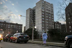 A resident watches as firefighters work at a high-rise fire in the 7100 block of South Jeffery Boulevard. A resident watches as firefighters work at a high-rise fire in the 7100 block of South Jeffery Boulevard.