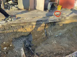 Wispy white smoke was emanating from a crack (red circle) in a curb in a parking lot that was adjacent to the communications closet (and adjoining electrical closet) when members of FCFRD’s Engine 410 arrived. The path of the service lines to the sidewalk also are visible. To its left is the communications conduit, to which the underground event migrated. Wispy white smoke was emanating from a crack (red circle) in a curb in a parking lot that was adjacent to the communications closet (and adjoining electrical closet) when members of FCFRD’s Engine 410 arrived. The path of the service lines to the sidewalk also are visible. To its left is the communications conduit, to which the underground event migrated.