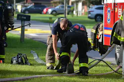 Firefighters roll a 3-inch high-flow feeder supply line. Firefighters roll a 3-inch high-flow feeder supply line.