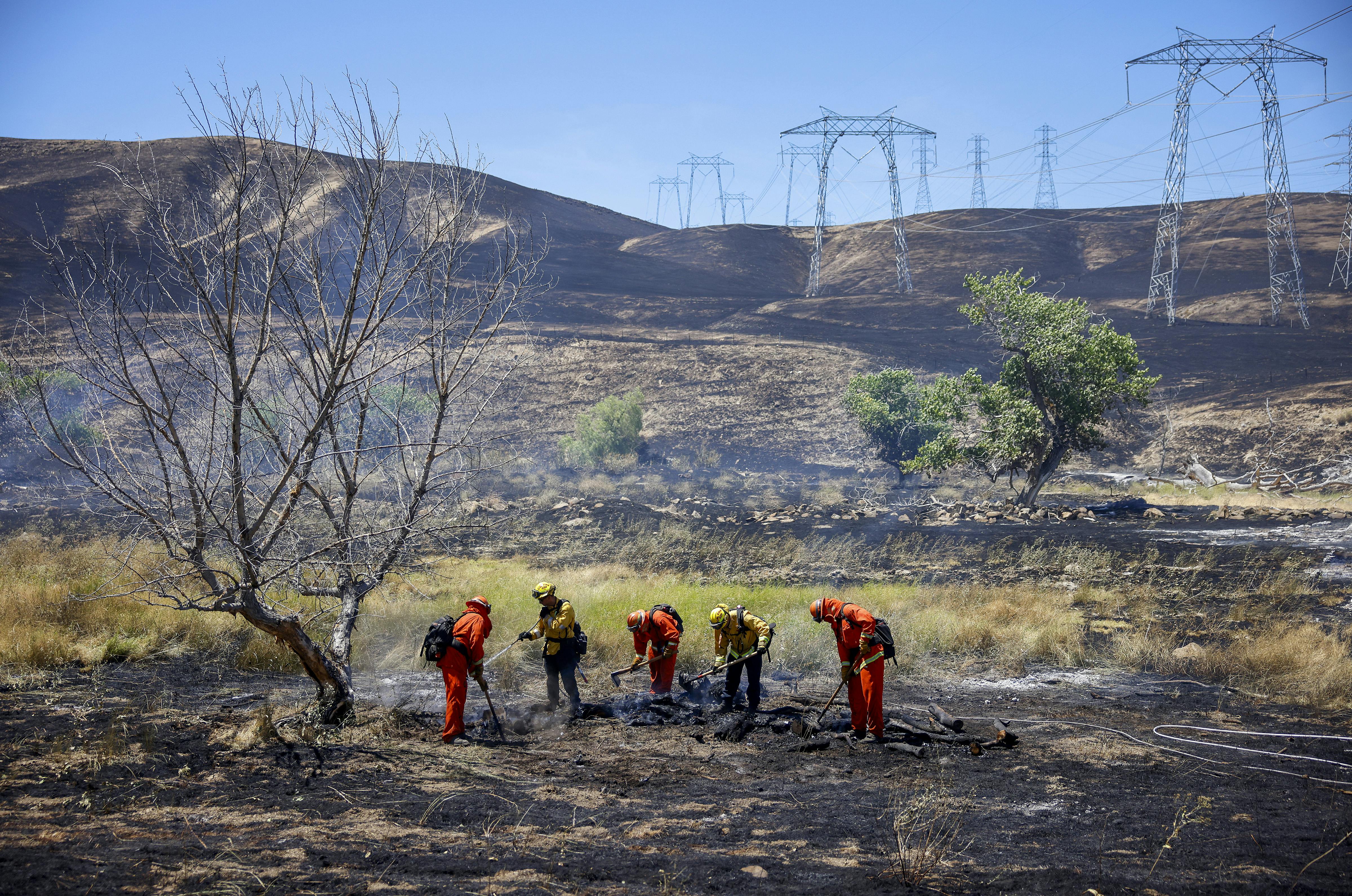 Firefighters work on the Corral Fire in Tracy, CA.