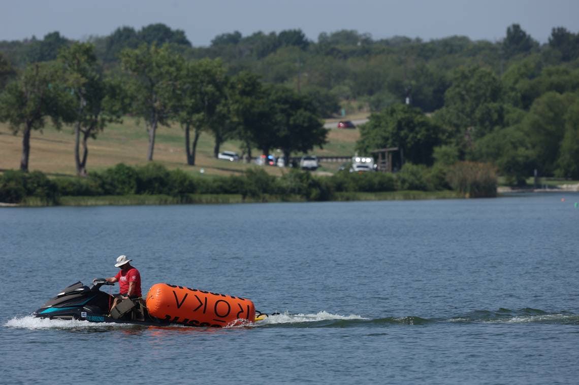 A jet skier pulls in buoys from the CrossFit Games at Marine Creek Lake in Fort Worth where athlete Lazar &Dstrok;uki&cacute; drowned.