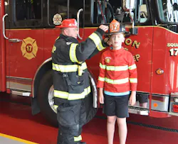 Jaxon Aldridge and Firefighter Sean Joyce of the Aston Township, PA, Fire Department’s (ATFD) exchange hats as they talk about what real firefighters wear. Jaxon Aldridge and Firefighter Sean Joyce of the Aston Township, PA, Fire Department’s (ATFD) exchange hats as they talk about what real firefighters wear.