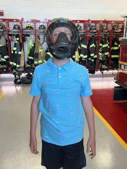 Aldridge tries on a breathing mask to lower fear of what a firefighter will look like in a rescue situation. Aldridge tries on a breathing mask to lower fear of what a firefighter will look like in a rescue situation.
