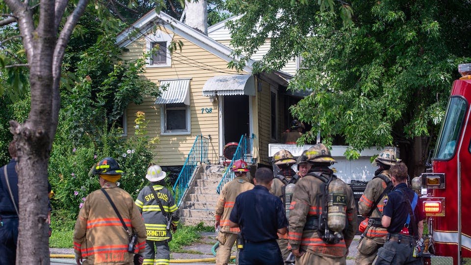 Syracuse firefighters at the scene of one of four house fires.