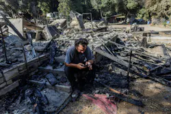 Garrett Keene sits on the front steps of his home that was destroyed in the Airport fire in El Cariso Village on Sept. 12 in Lake Elsinore, California. Garrett Keene sits on the front steps of his home that was destroyed in the Airport fire in El Cariso Village on Sept. 12 in Lake Elsinore, California.