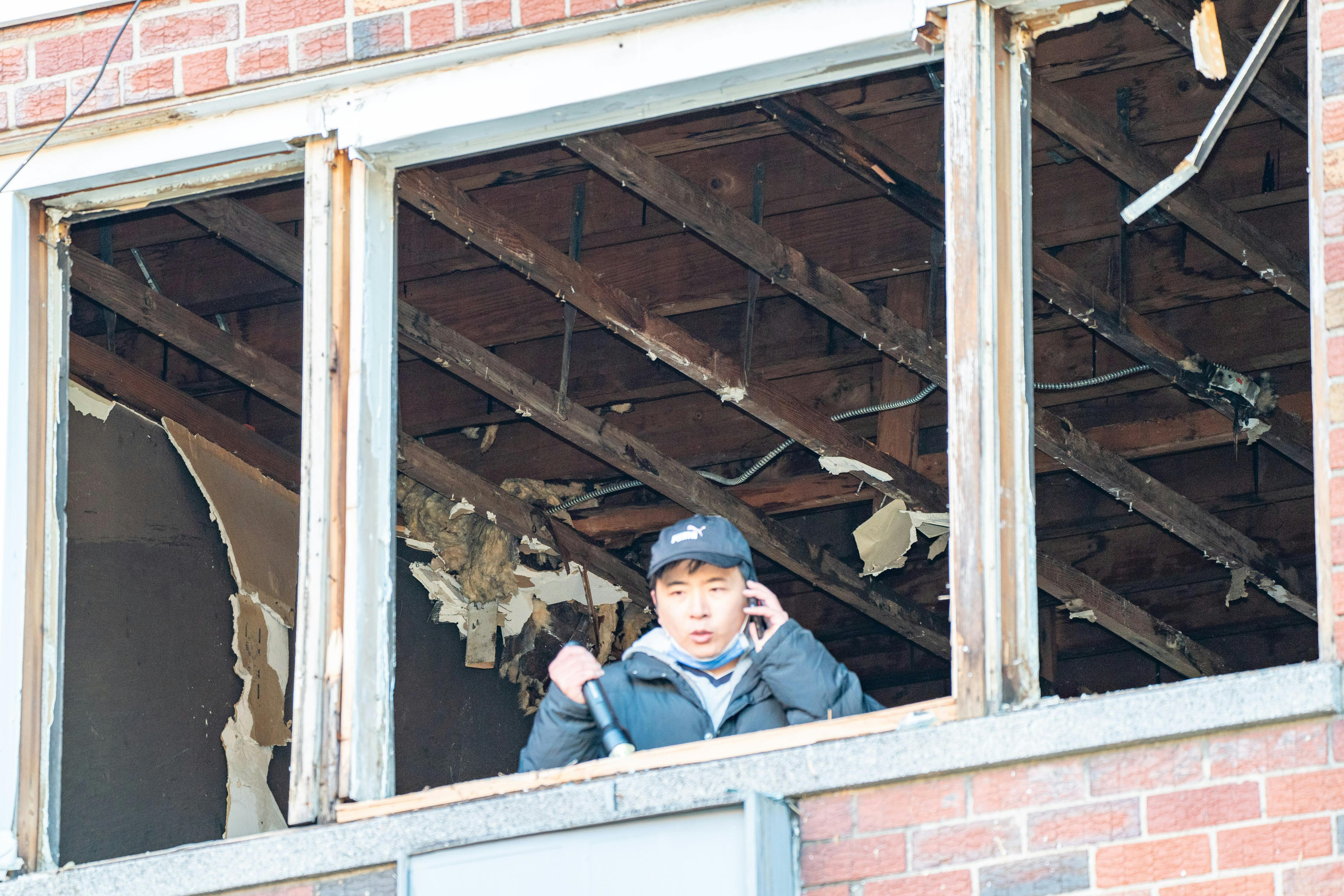 An FDNY investigator examines the Bronx fire scene where a lithium-ion battery sparked a deadly fire.