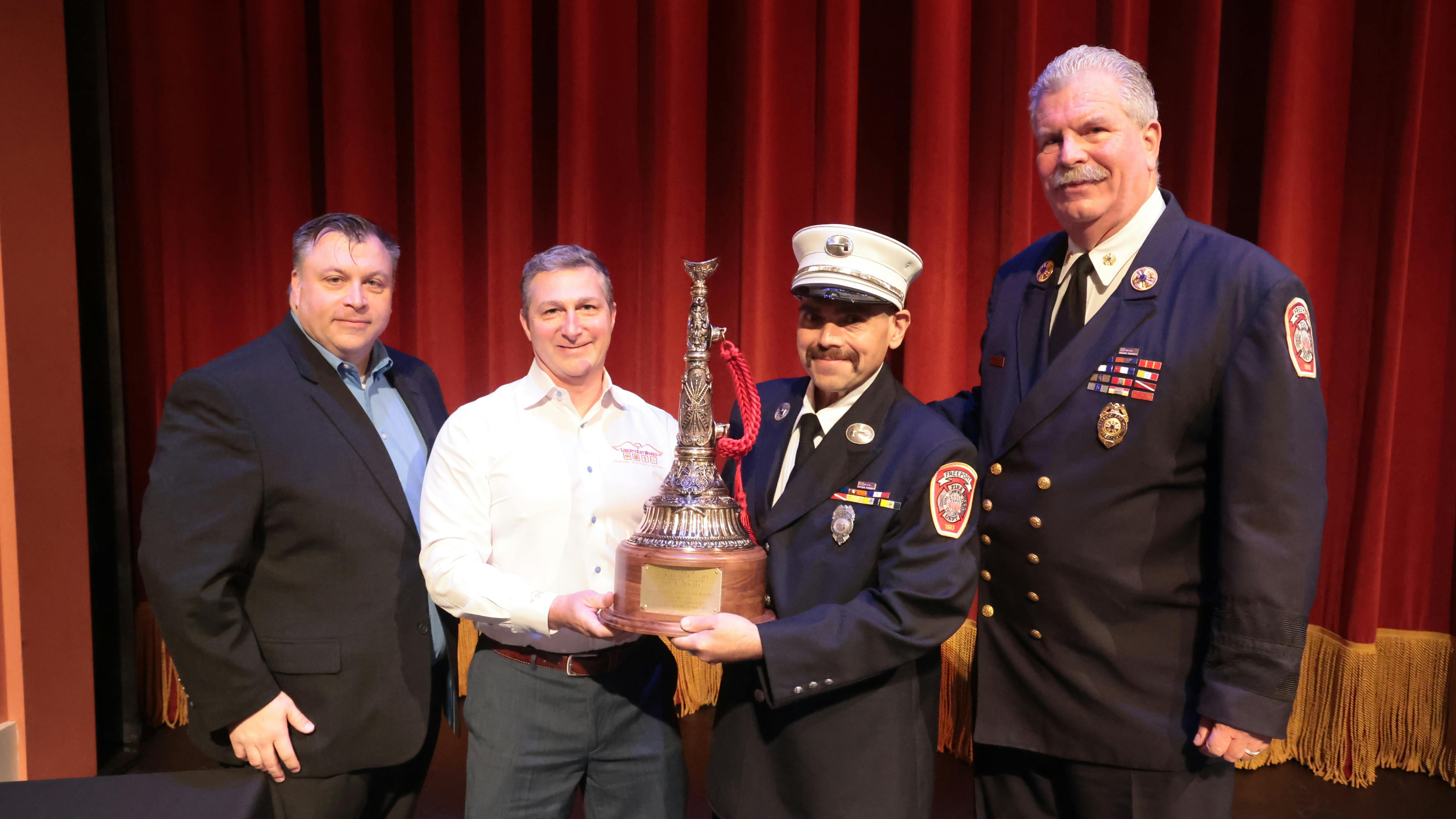 Freeport firefighter Petros Mestheneas (second from right) received the Michael O. McNamee Award of Valor at FireFusion for his rescue efforts of two firefighters. He receievd the award from FireFusion Conference Director Peter Matthews (left to right), Robert Daus Jr. from Liberty Artworks and Freeport Fire Department Executive Director Ray Maguire.
