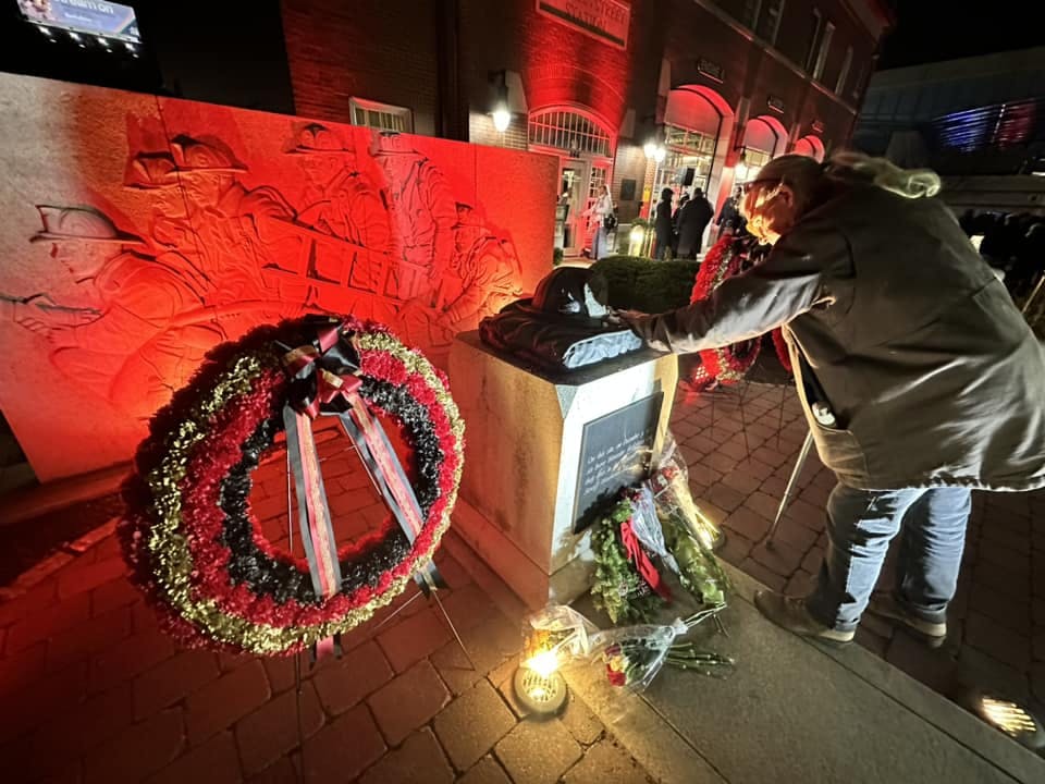A retired firefighter touches the memorial for the Worcester Cold Storage Fire after the 25th anniversary memorial service.