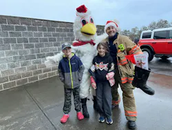 Corbett, OR, Fire District firefighter Corey Sippel and two of his children pose with the Christmas Chicken during school drop off. Corbett, OR, Fire District firefighter Corey Sippel and two of his children pose with the Christmas Chicken during school drop off.
