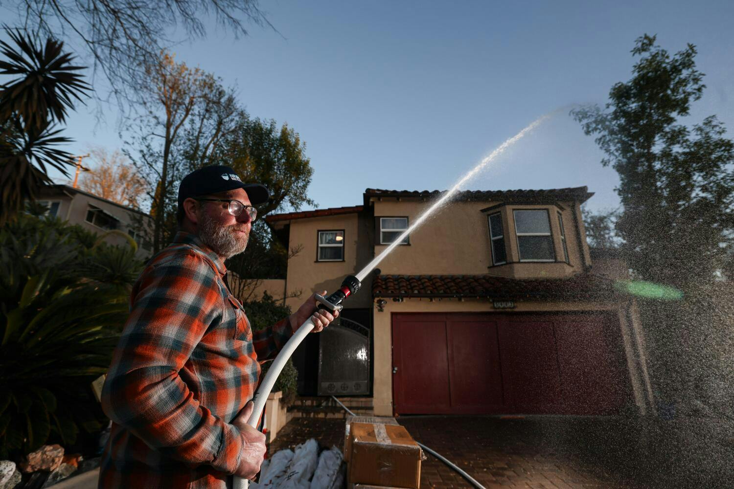 David Whitman, who has seen an uptick in hydrant sales, demonstrates a system at his South Pasadena house.