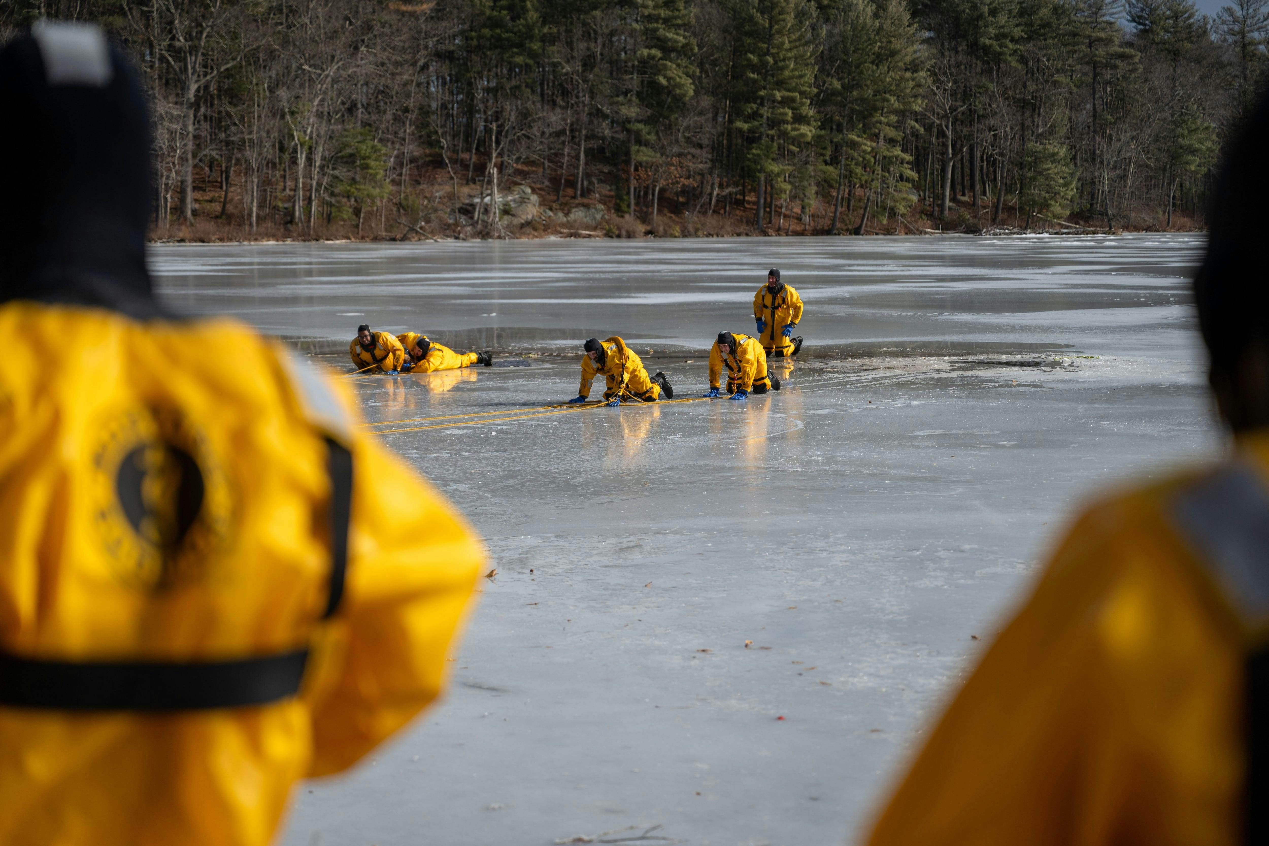 Firefighter practice rescuing each other using the life sling, a piece of equipment that is used to go around victims that have fallen through the ice.