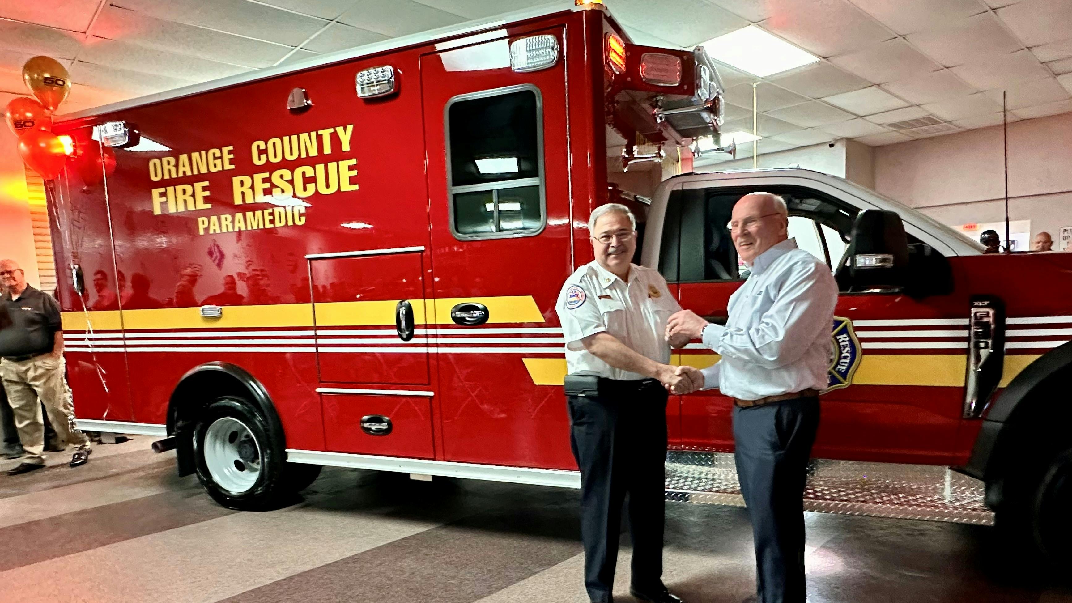 President of the REV Ambulance Division, Mark Van Arnam, hands over the keys to Orange County Fire Chief James Fitzgerald for their latest delivery. Orange County Fire Rescue Department has been a Wheeled Coach customer since 1979.