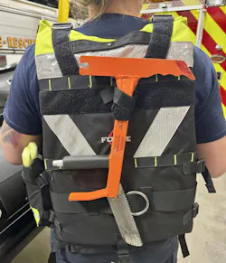 A fellow rescuer easily can access a Glas-Master glass removal tool when it’s attached to the back of a PFD by a hook-and-loop strap. It can fall away from the rescuer if it becomes entangled during swimming. A section of hose with a bungee strap can be placed around the blade to protect from the sharp edges. A fellow rescuer easily can access a Glas-Master glass removal tool when it’s attached to the back of a PFD by a hook-and-loop strap. It can fall away from the rescuer if it becomes entangled during swimming. A section of hose with a bungee strap can be placed around the blade to protect from the sharp edges.