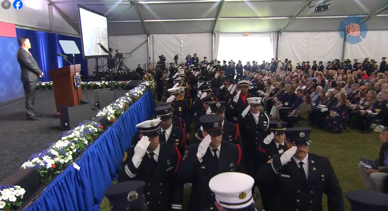 Firefighters salute the families and colleagues of the fallen.