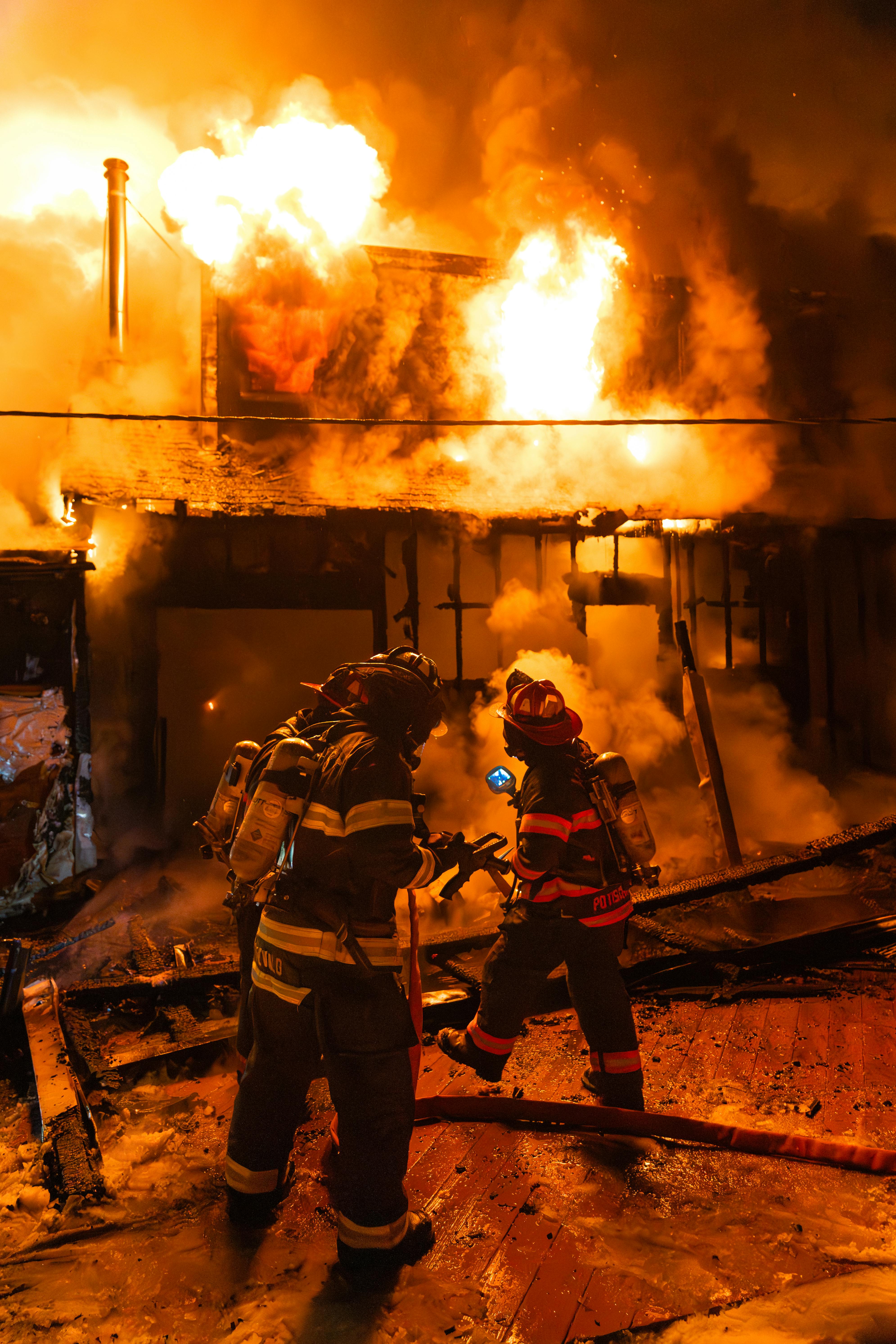 Firefighters of the Rockland County Department of Fire & Emergency Services found a fire burning in the rear of a large, two-story house and extending rapidly up the exterior and into the attic. An interior attack was thwarted by wind-driven flames and the lack of hydrants in the area. A portable water tank and tanker shuttle were put into operation. Crews worked in cold conditions for several hours to bring the fire under control. Shown: Mutual-aid firefighters from the Hillcrest Volunteer Fire Company await water to mount an attack in the rear of the house.