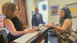 Cylina Cervantes, right, hands a legislative staff member while Westfield Firefighter Josh Southerland listens. Cylina Cervantes, right, hands a legislative staff member while Westfield Firefighter Josh Southerland listens.