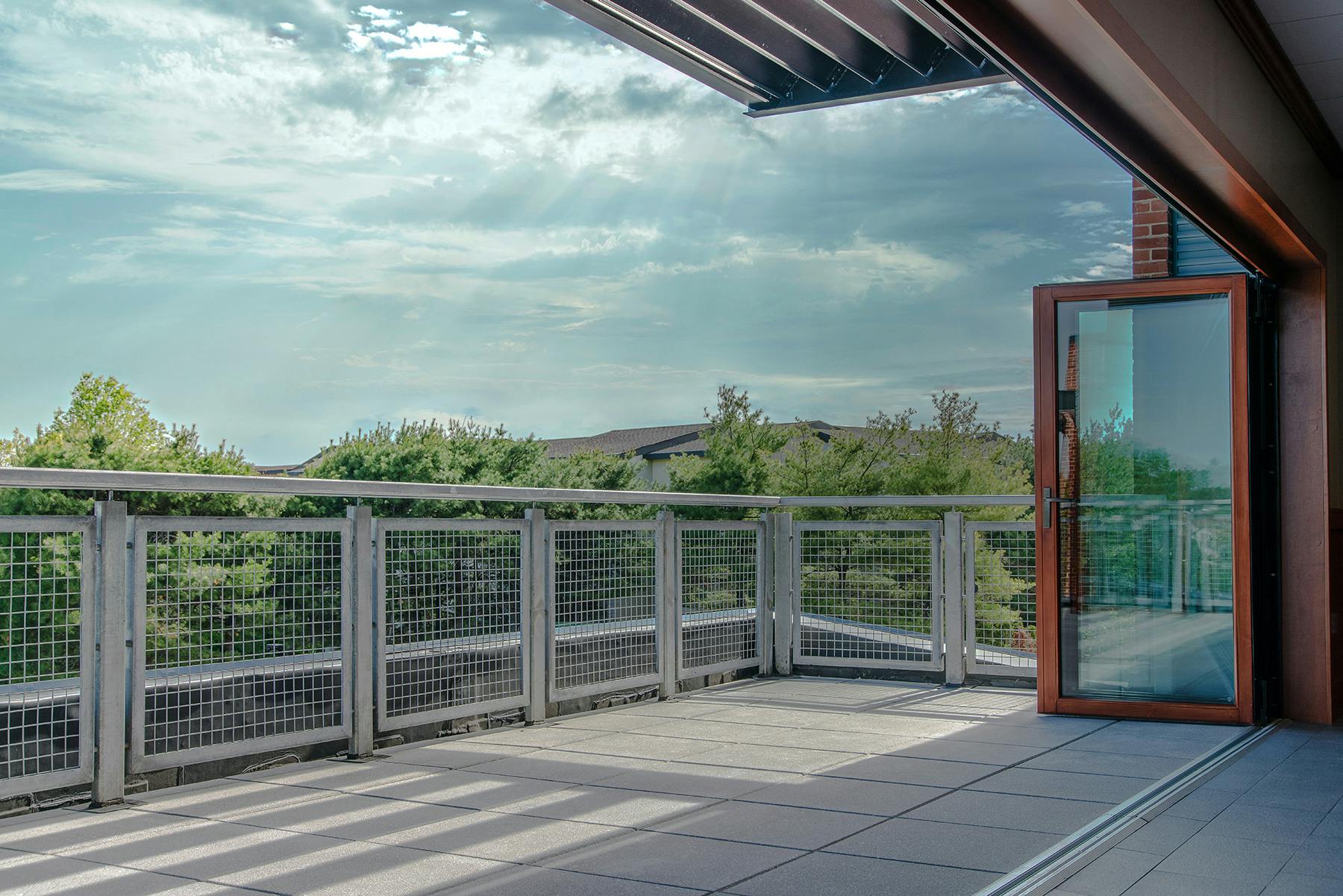 Biophilic design in fire stations blurs the line between indoor and outdoor spaces, including the use of folding walls or pass-through windows to connect day rooms and recreational spaces.