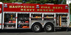 The Hauppauge, NY, Fire Department had Rescue 1 build its new rescue using a Spartan Gladiator four-door cab while maintaining a walk-in body. The roll-up doors provide a cleaner access to all tools and equipment. Note the use of aluminum tread plate around the tandem-axle area. The Hauppauge, NY, Fire Department had Rescue 1 build its new rescue using a Spartan Gladiator four-door cab while maintaining a walk-in body. The roll-up doors provide a cleaner access to all tools and equipment. Note the use of aluminum tread plate around the tandem-axle area.