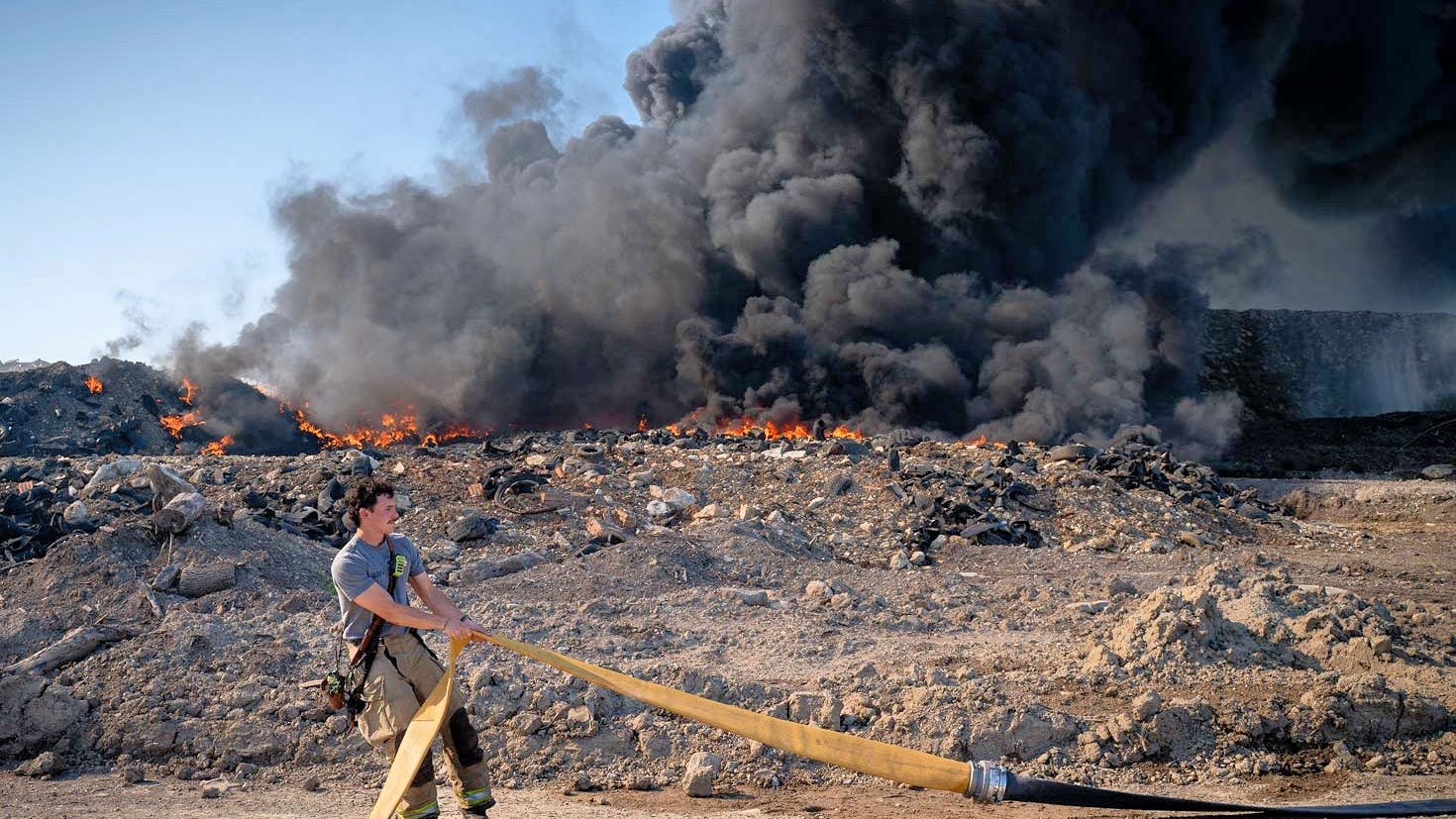 There are hundreds of abbreviations that fit into a firefighter's workday. Here, a firefighter stretches LDH, or large diameter hose, to help establish a water supply.