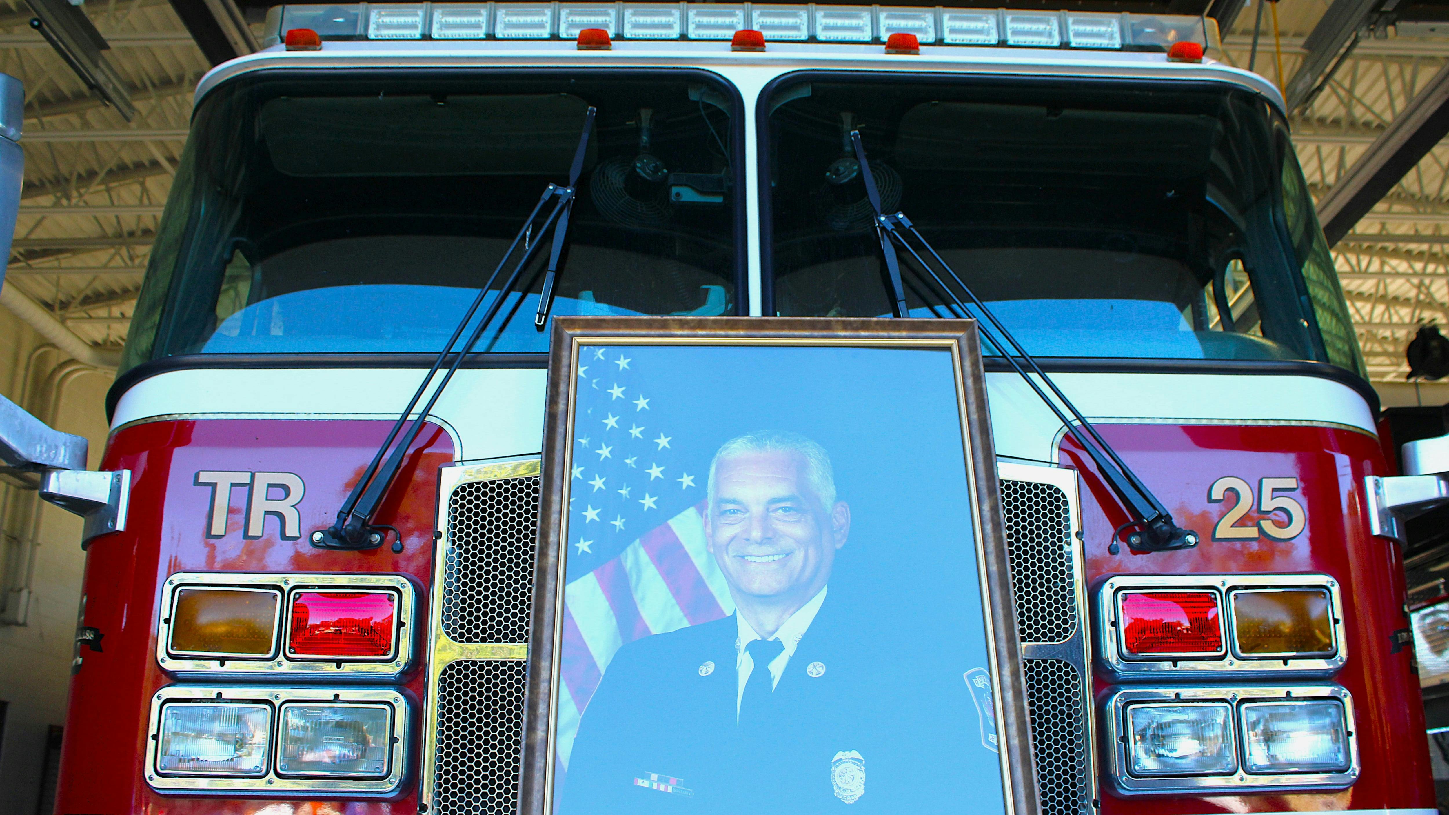 A portrait of the late Alexander G. Trenier sits on the front of a truck in the Mobile fire station that bears his name.