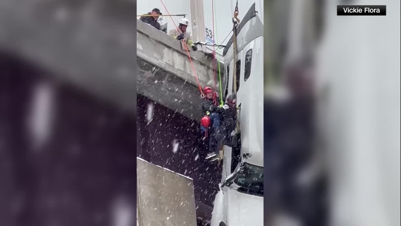 Emergency crews rescue tractor-trailer driver dangling off West Virginia bridge