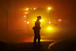 A firefighter turns as smoke is blown down on them while providing structure protection in Altadena, CA, on Jan. 7, 2025. A firefighter turns as smoke is blown down on them while providing structure protection in Altadena, CA, on Jan. 7, 2025.
