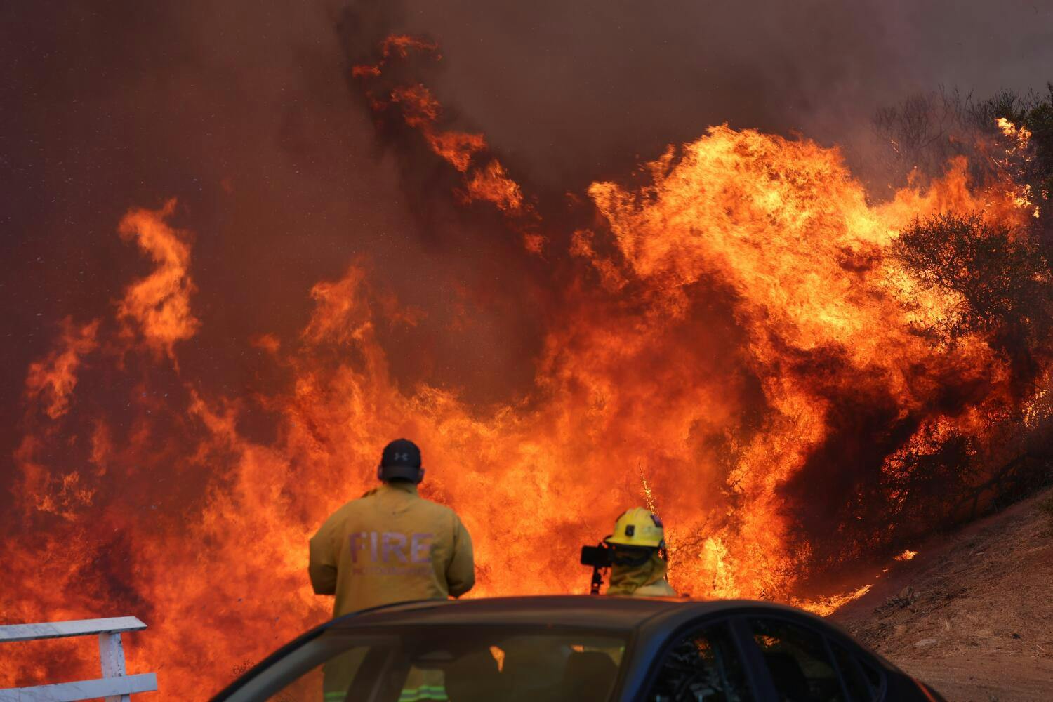 Firefighters were surrounded by raging flames in Palisades on Jan. 7, 2025.
