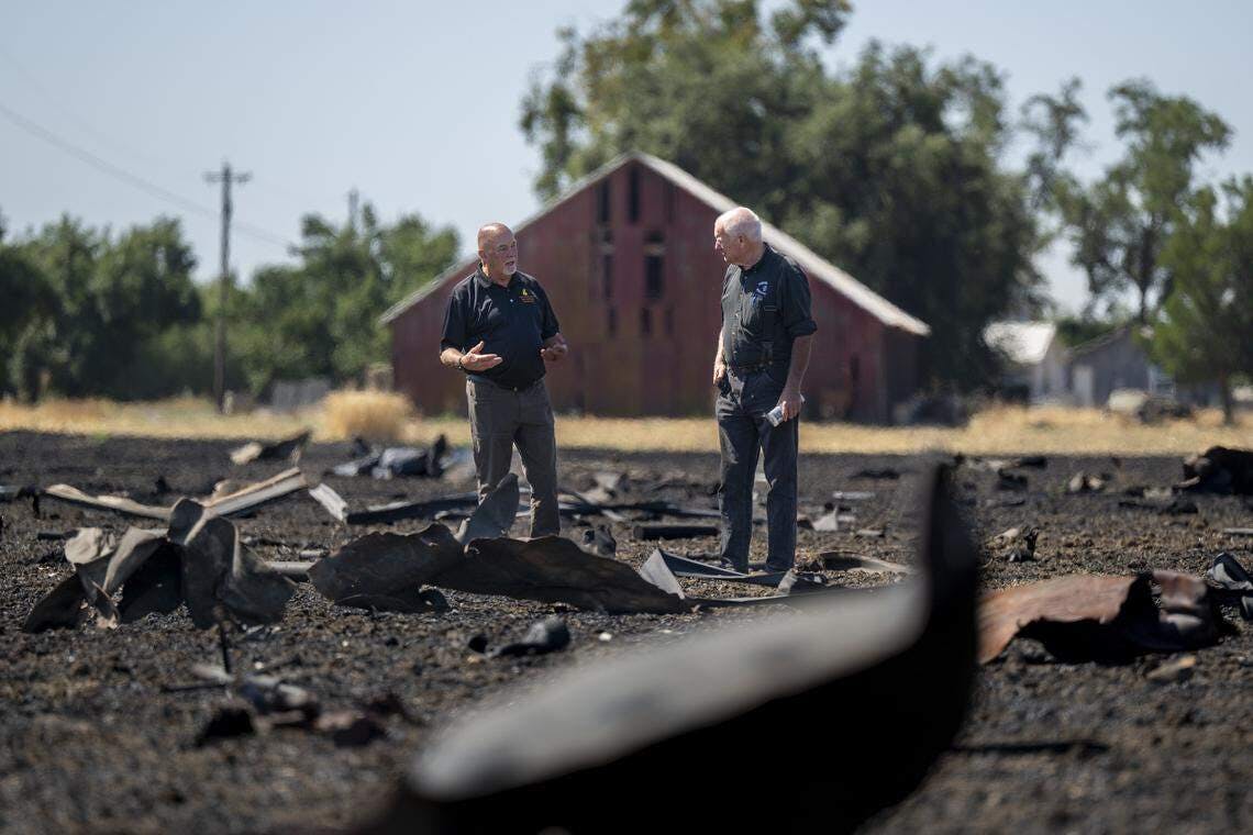 Fire investigators examine debris from the Devastating Pyrotechnics explosion in a nearby field in Esparto on July 21, 2025,