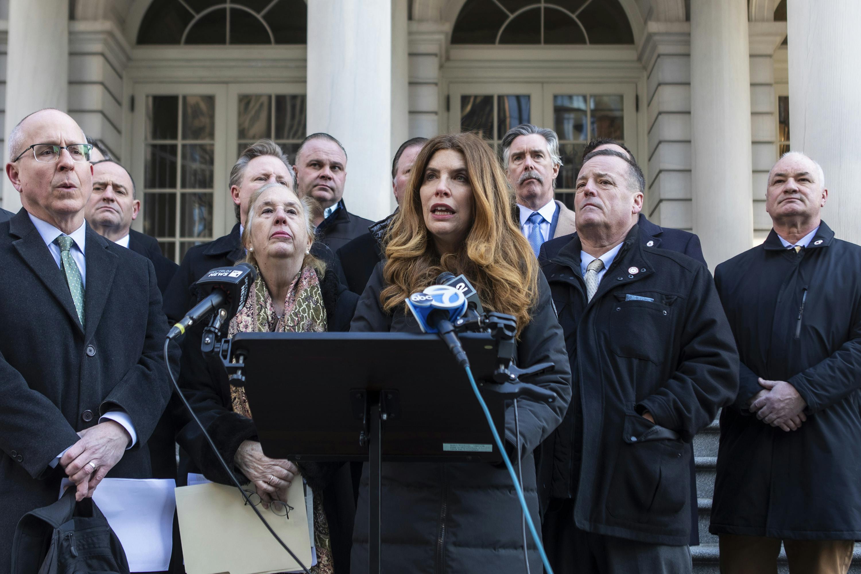 New York City Council Speaker Julie Menin (at microphone) and Council member Gale Brewer appear at a press conference demanding transparency on post-9/11 air quality knowledge.