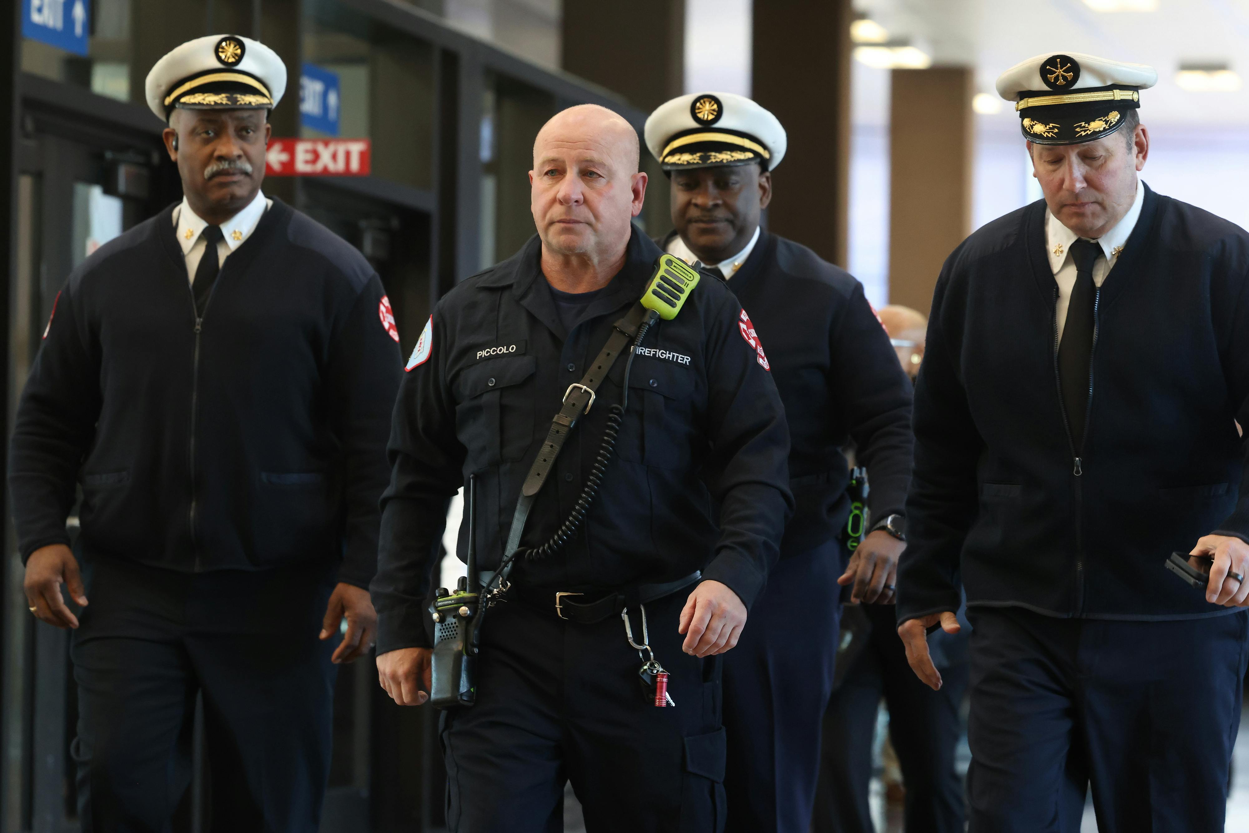 Chicago firefighters arrive at the hearing for the man accused of setting fire where a colleague was killed.