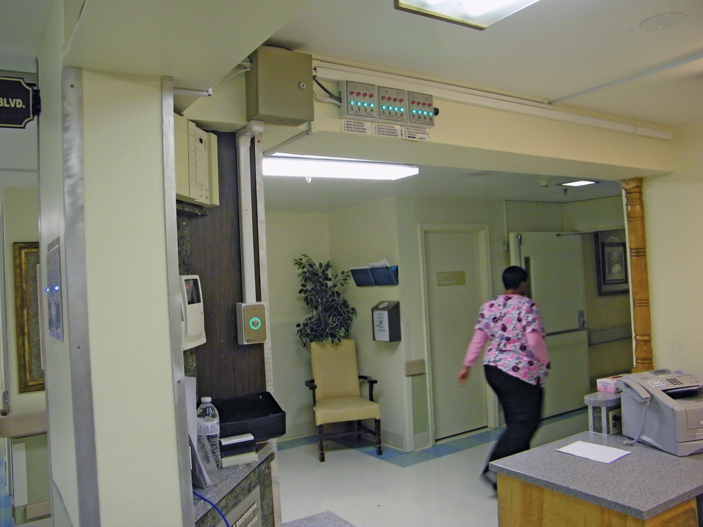 Centrally monitored door alarm