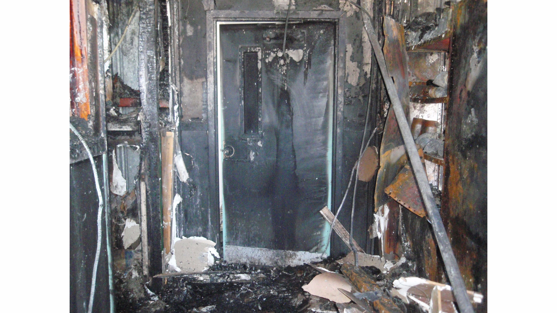 Extreme fire damage on closed side of door