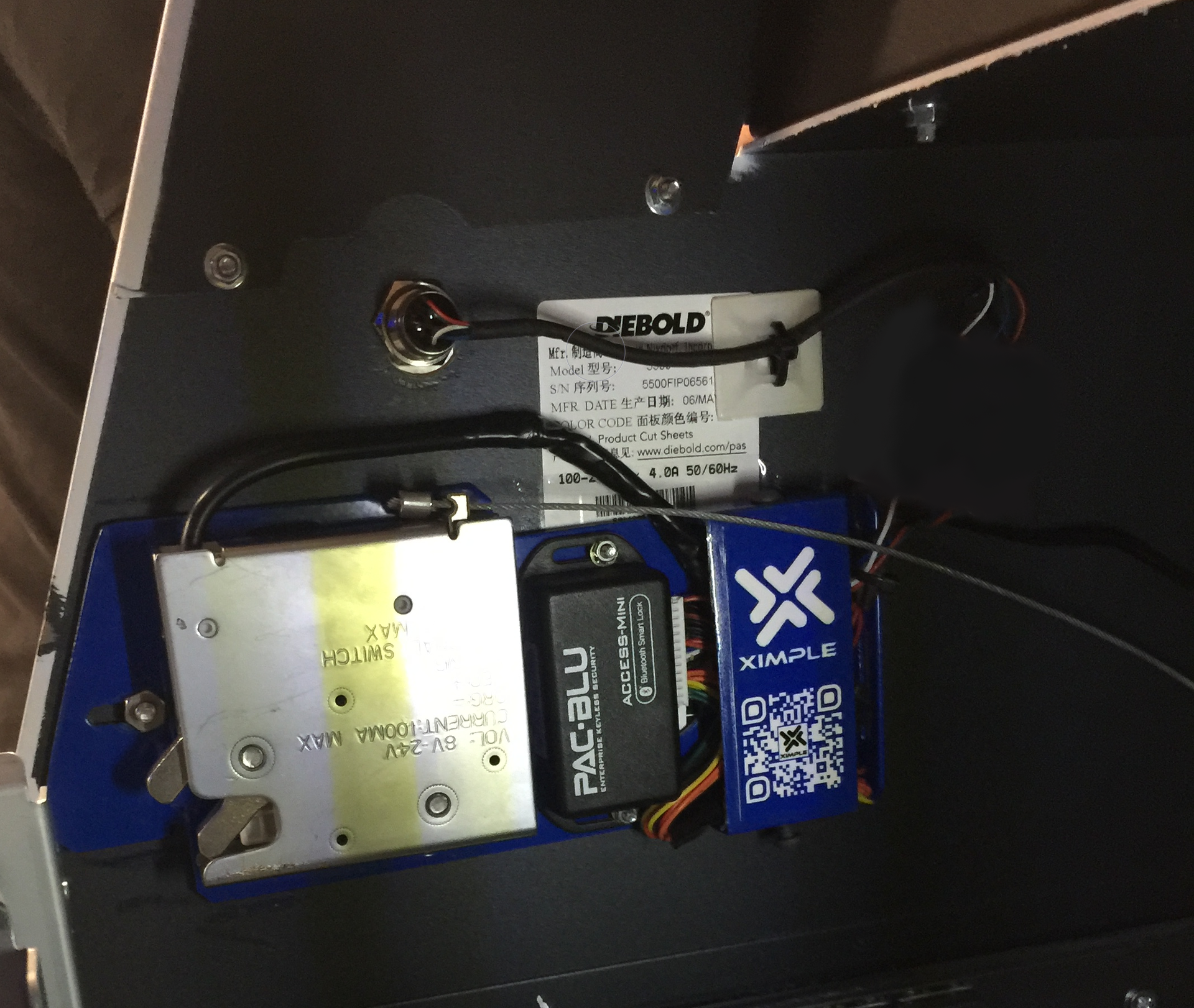 A PAC-BLU ACCESS-Mini with a spring-loaded cabinet lock and a tri-color button wired into it for an ATM