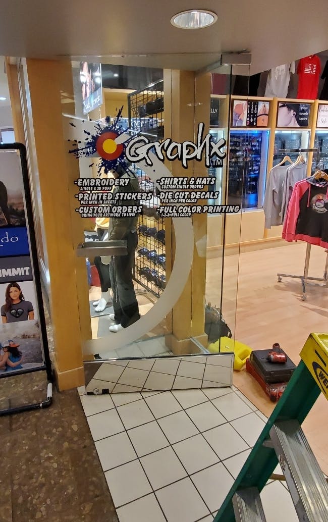 Photo 1. Herculite door with broken lock mechanism