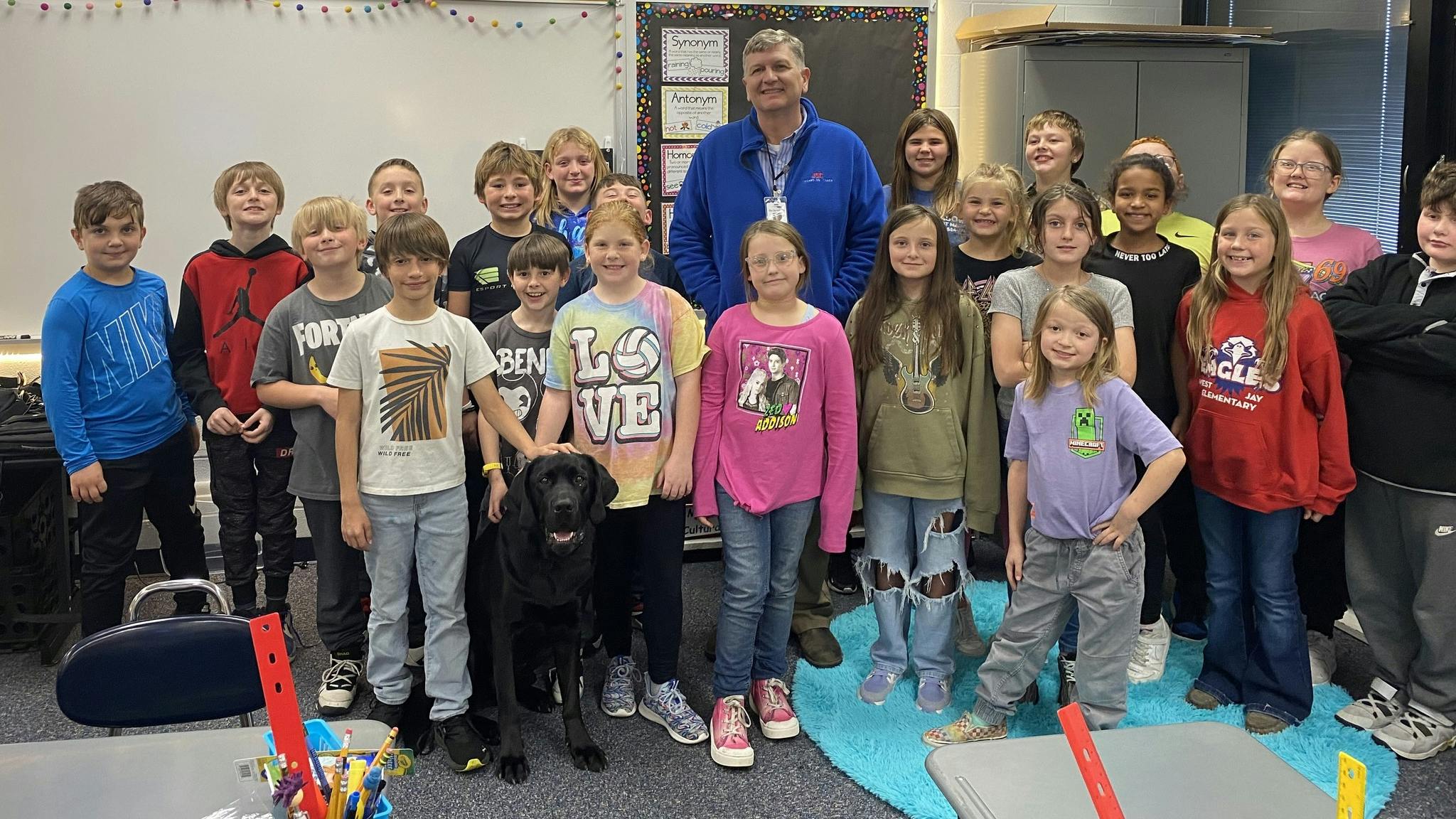Jay County School Superintendent Jeremy Gulley and the district's weapon's detecting dog, a Black Labrador named Jack, at one of the five elementary schools in the district,