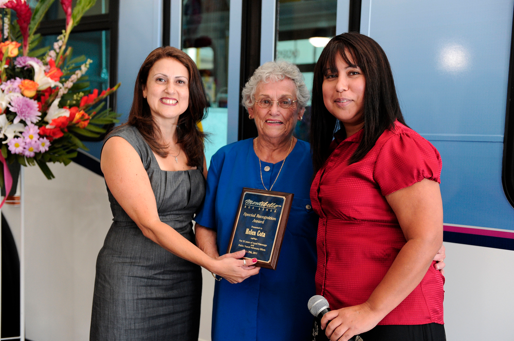 Montebello Bus Lines Assistant Director of Transporation Alva Carrasco (L) and Director of Transportation Aurora Jackson (R),congratulate Helen Cota for being the bus lines longest riding passenger. Cota has be riding the bus lines regularly for 52 years. The East Los Angeles resident rides the bus to her job at the Montebello Senior Center and to run errands. She was recognized at Montebello Bus Lines 80th Anniversary celebration.